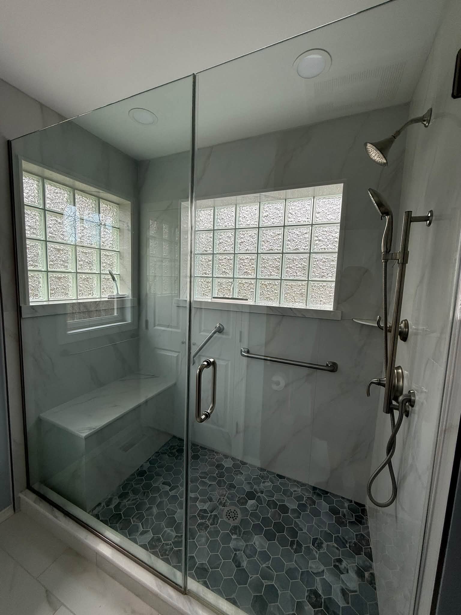 Custom shower with glass doors and tiled surround
